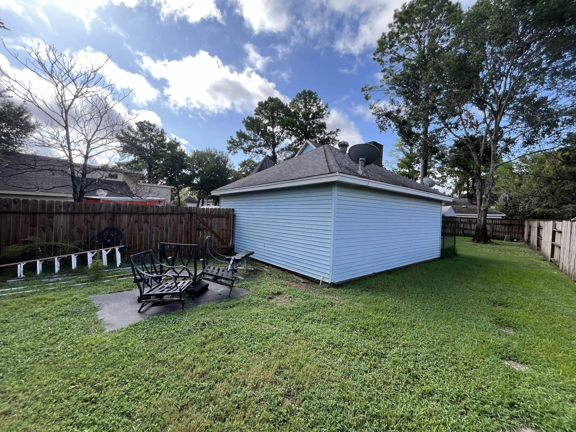 12007 Carriage Ridge Court Houston, TX 77070 - Photo 14 of 14 a view of backyard with table and chairs and a large tree
