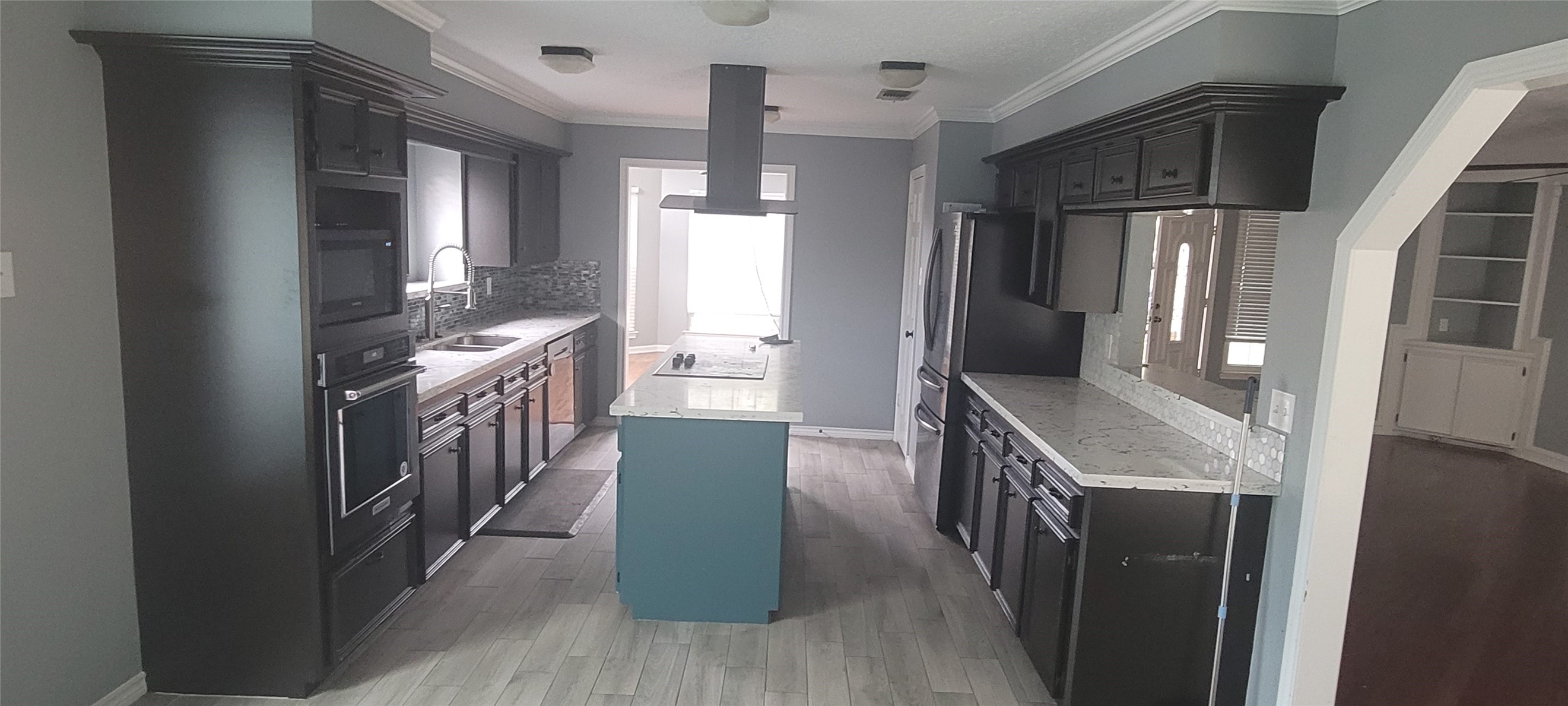12007 Carriage Ridge Court Houston, TX 77070 - Photo 3 of 14 a kitchen with granite countertop a refrigerator a sink and wooden floors
