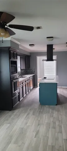 a kitchen with stainless steel appliances a stove and a refrigerator