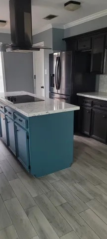 a kitchen with stainless steel appliances granite countertop a sink and a stove