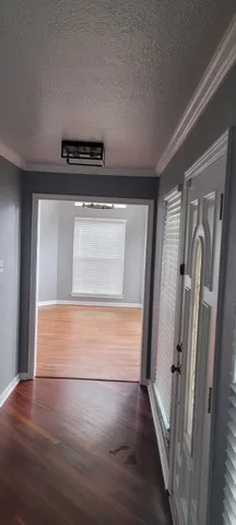 a view of walk in closet with wooden floor
