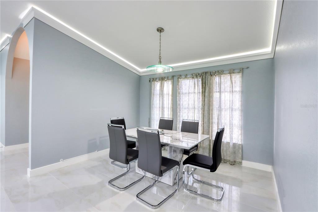 2500 Rio Lisbo Court Punta Gorda, FL 33950 - Photo 14 of 71 a dining room with furniture large windows and wooden floor