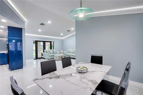 a kitchen with kitchen island granite countertop stainless steel appliances a sink stove and refrigerator