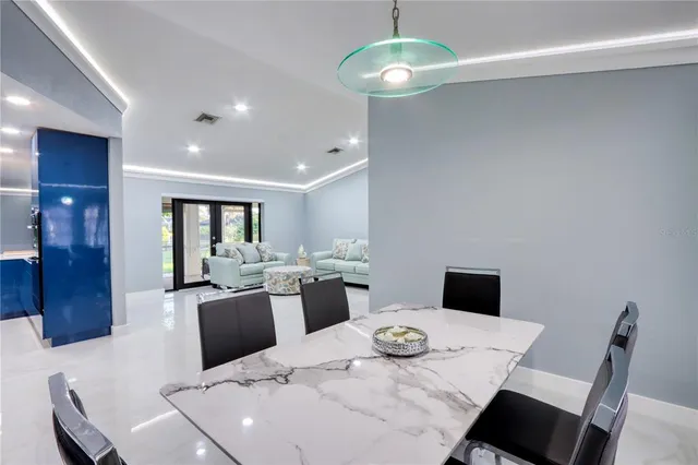 a kitchen with kitchen island granite countertop stainless steel appliances a sink stove and refrigerator