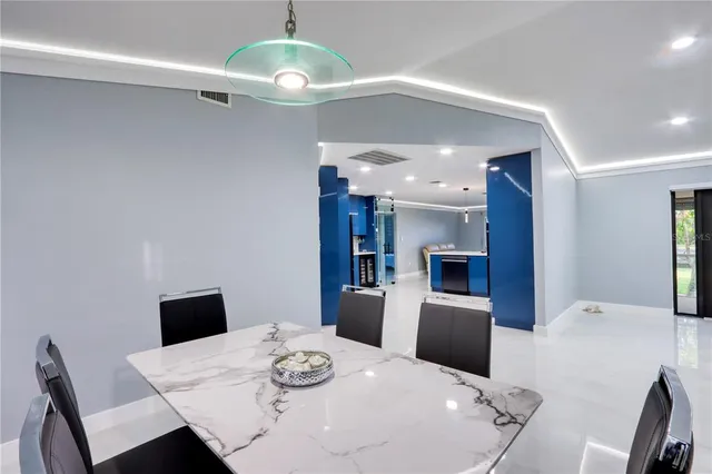 a kitchen with kitchen island granite countertop a sink and refrigerator