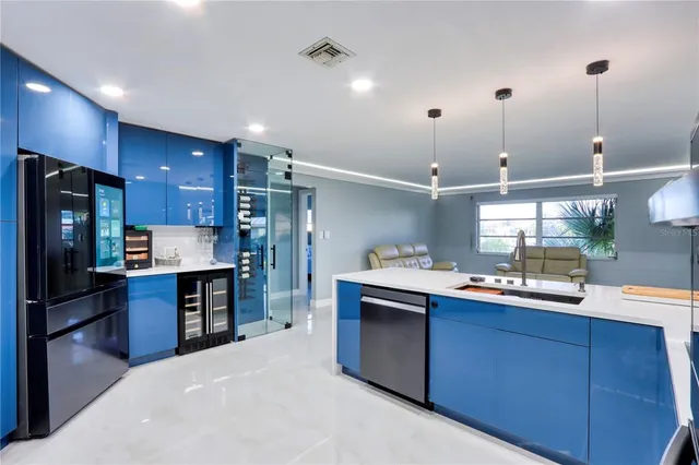 a kitchen with stainless steel appliances a sink stove and cabinets