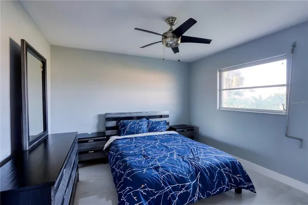 a living room with furniture and a floor to ceiling window