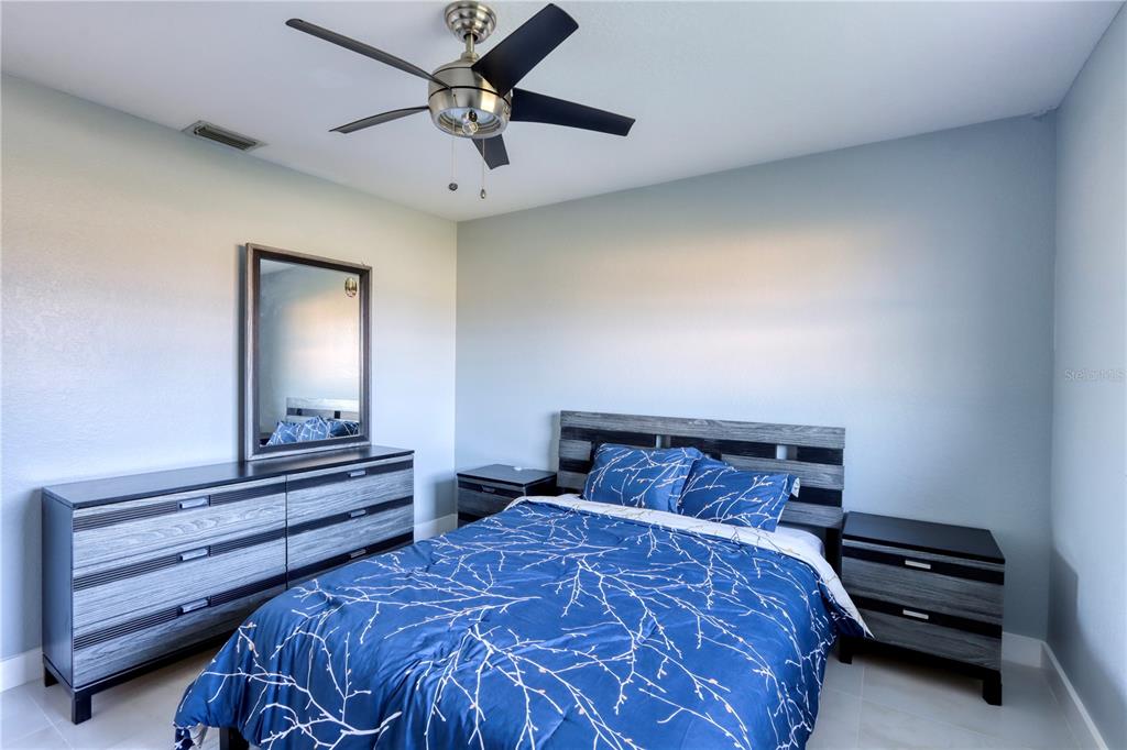 2500 Rio Lisbo Court Punta Gorda, FL 33950 - Photo 35 of 71 a bedroom with a bed and a chandelier