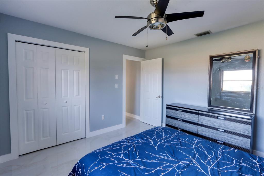2500 Rio Lisbo Court Punta Gorda, FL 33950 - Photo 38 of 71 a bedroom with a bed and a chandelier