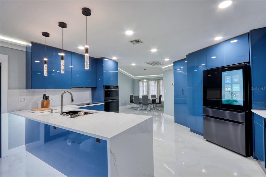 2500 Rio Lisbo Court Punta Gorda, FL 33950 - Photo 39 of 71 a kitchen with a sink a counter top space stainless steel appliances and a center island