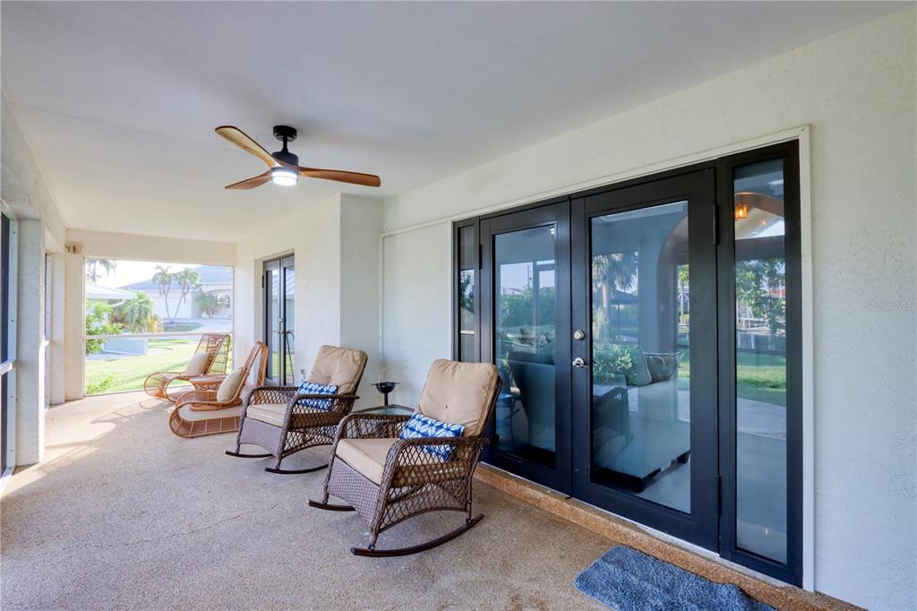 2500 Rio Lisbo Court Punta Gorda, FL 33950 - Photo 47 of 71 a living room with furniture and a floor to ceiling window