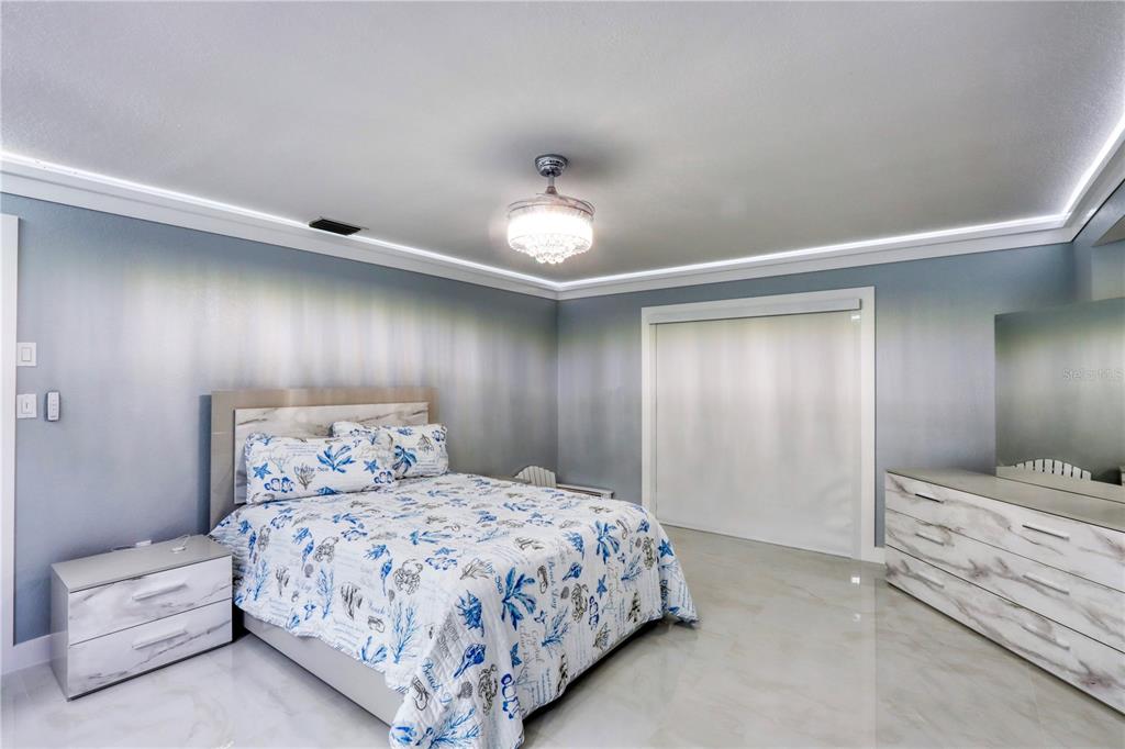 2500 Rio Lisbo Court Punta Gorda, FL 33950 - Photo 49 of 71 a bedroom with a bed and a chandelier