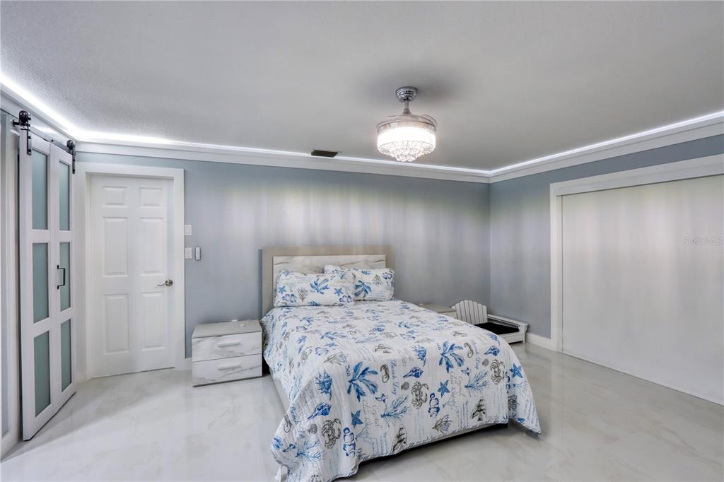 2500 Rio Lisbo Court Punta Gorda, FL 33950 - Photo 50 of 71 a bedroom with a bed and a chandelier