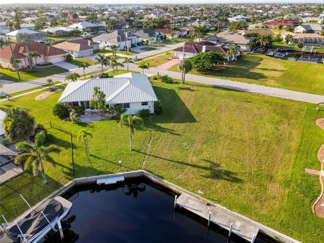an aerial view of residential houses with outdoor space and swimming pool