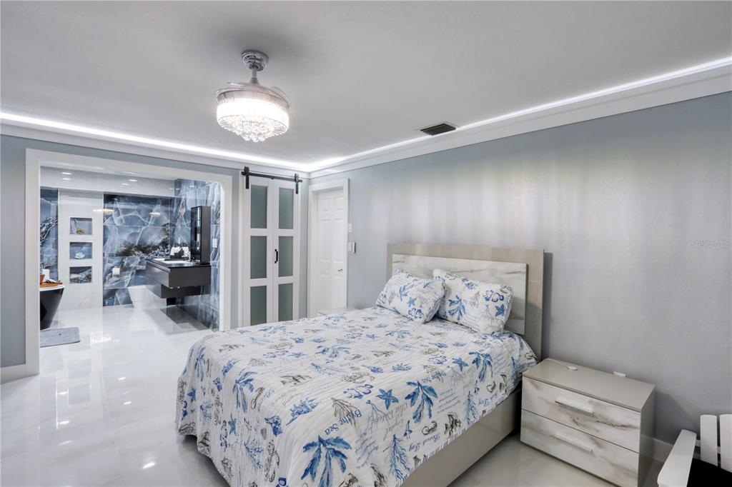 2500 Rio Lisbo Court Punta Gorda, FL 33950 - Photo 51 of 71 a bedroom with a large bed and a large mirror