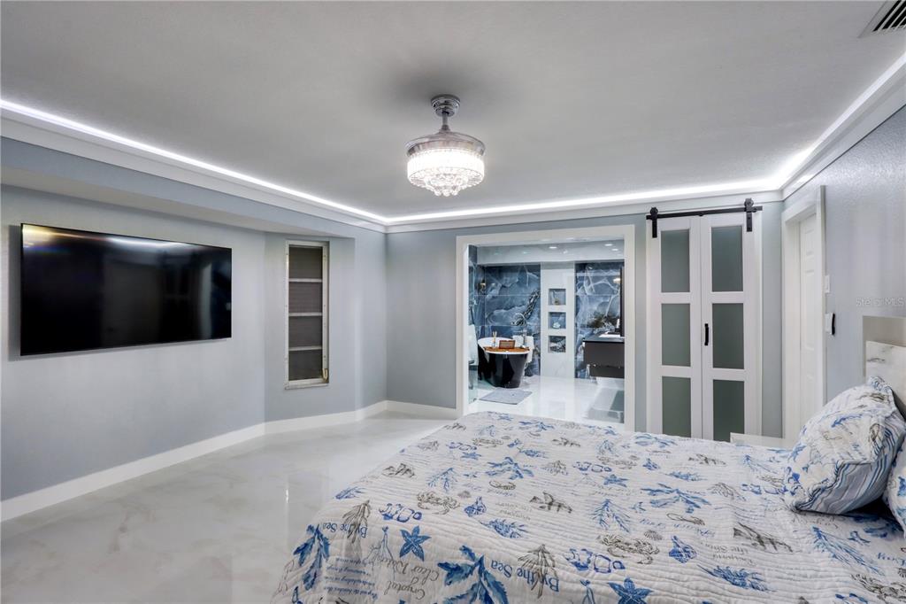 2500 Rio Lisbo Court Punta Gorda, FL 33950 - Photo 52 of 71 a bedroom with a bed and a flat screen tv