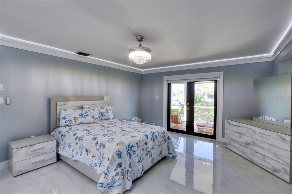 2500 Rio Lisbo Court Punta Gorda, FL 33950 - Photo 57 of 71 a bedroom with a large bed and a chandelier