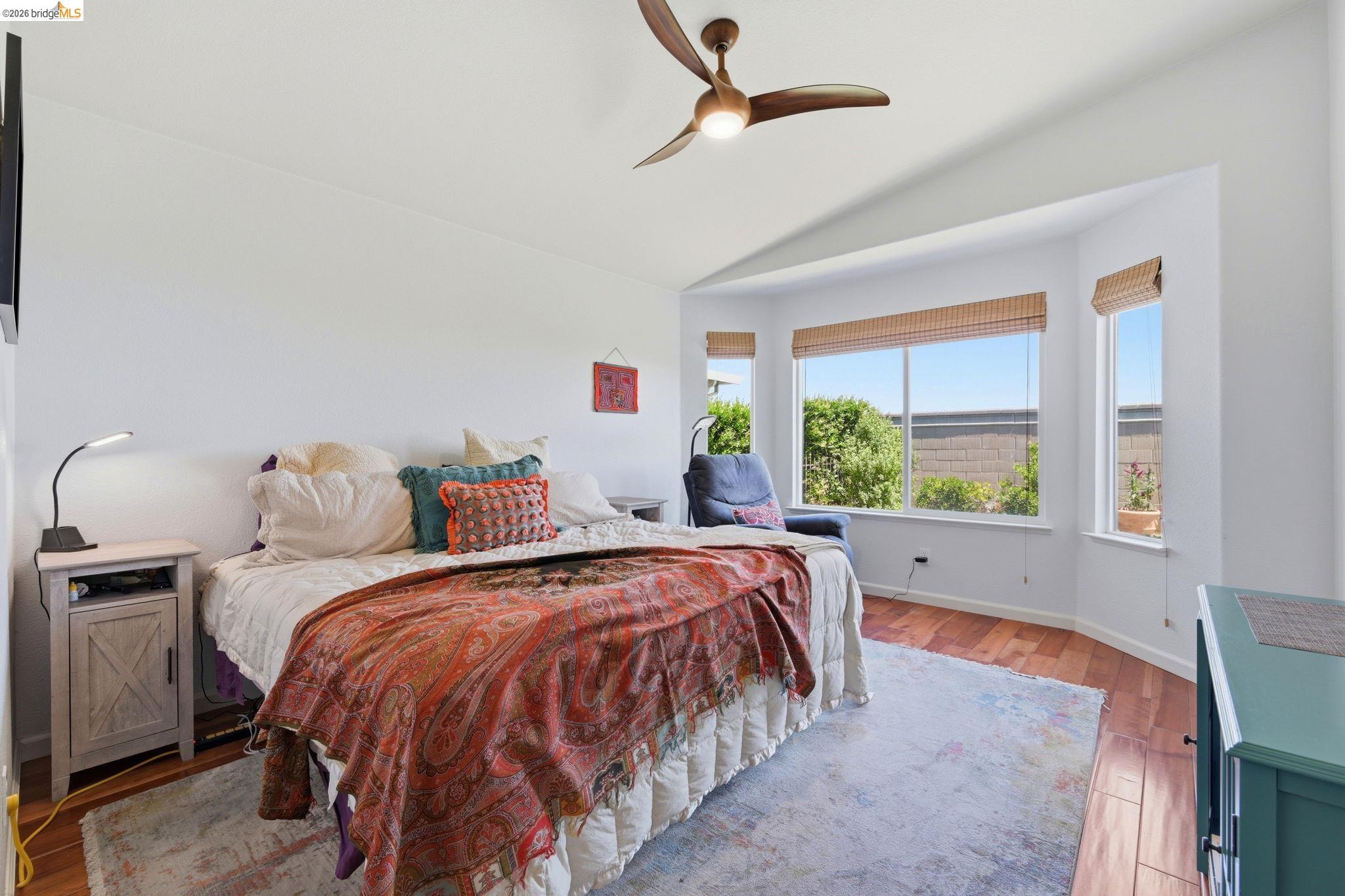 1024 Diamante Rio Vista, CA 94571 - Photo 15 of 27 Angled bay window with multiple large panes, wood-finish flooring, vaulted ceiling, and a ceiling fan with integrated lighting
