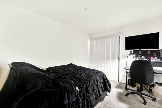 a bedroom with a bed and a mirror