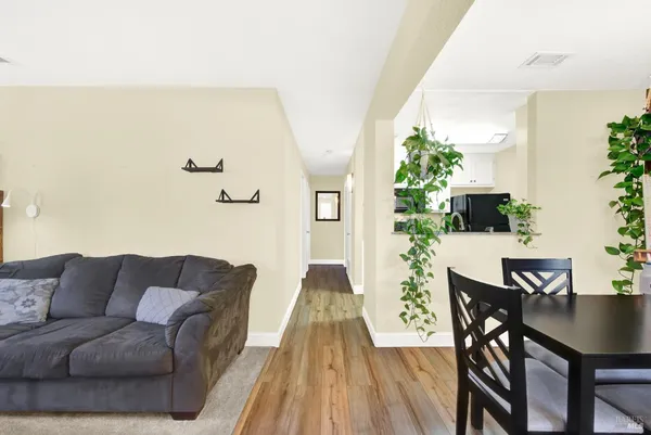 a living room with furniture and wooden floor