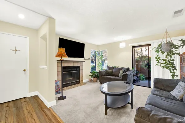 a living room with furniture a fireplace and a flat screen tv