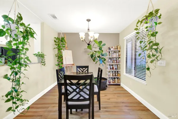 a dining room with furniture potted plants