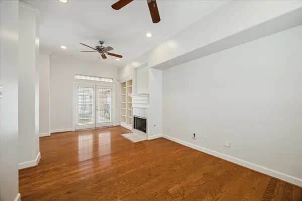 wooden floor in an empty room with a window