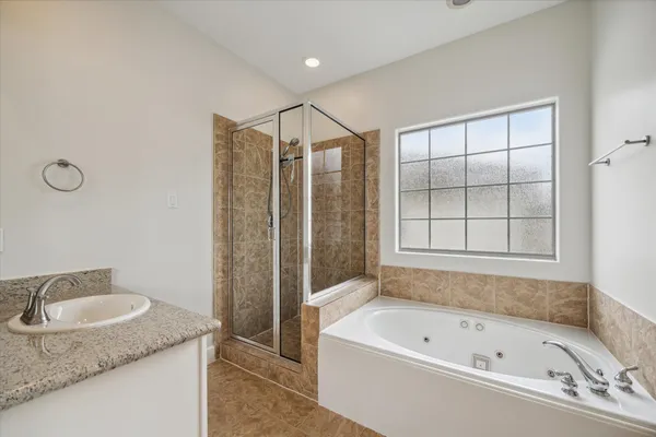 a bathroom with a granite countertop sink a toilet a mirror and shower