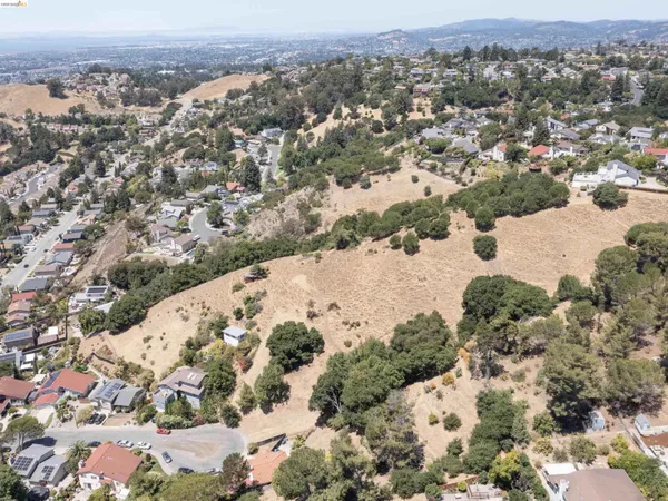 a view of a dry yard with mountain view