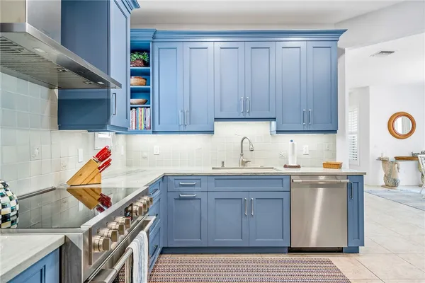 a kitchen with granite countertop a sink and cabinets
