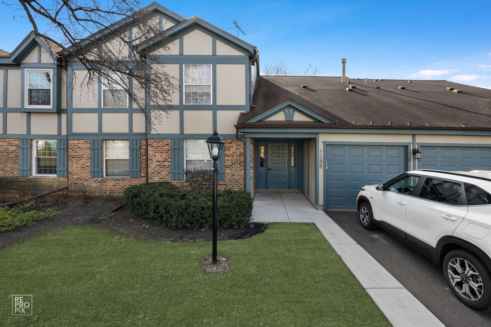 a front view of a house with garden