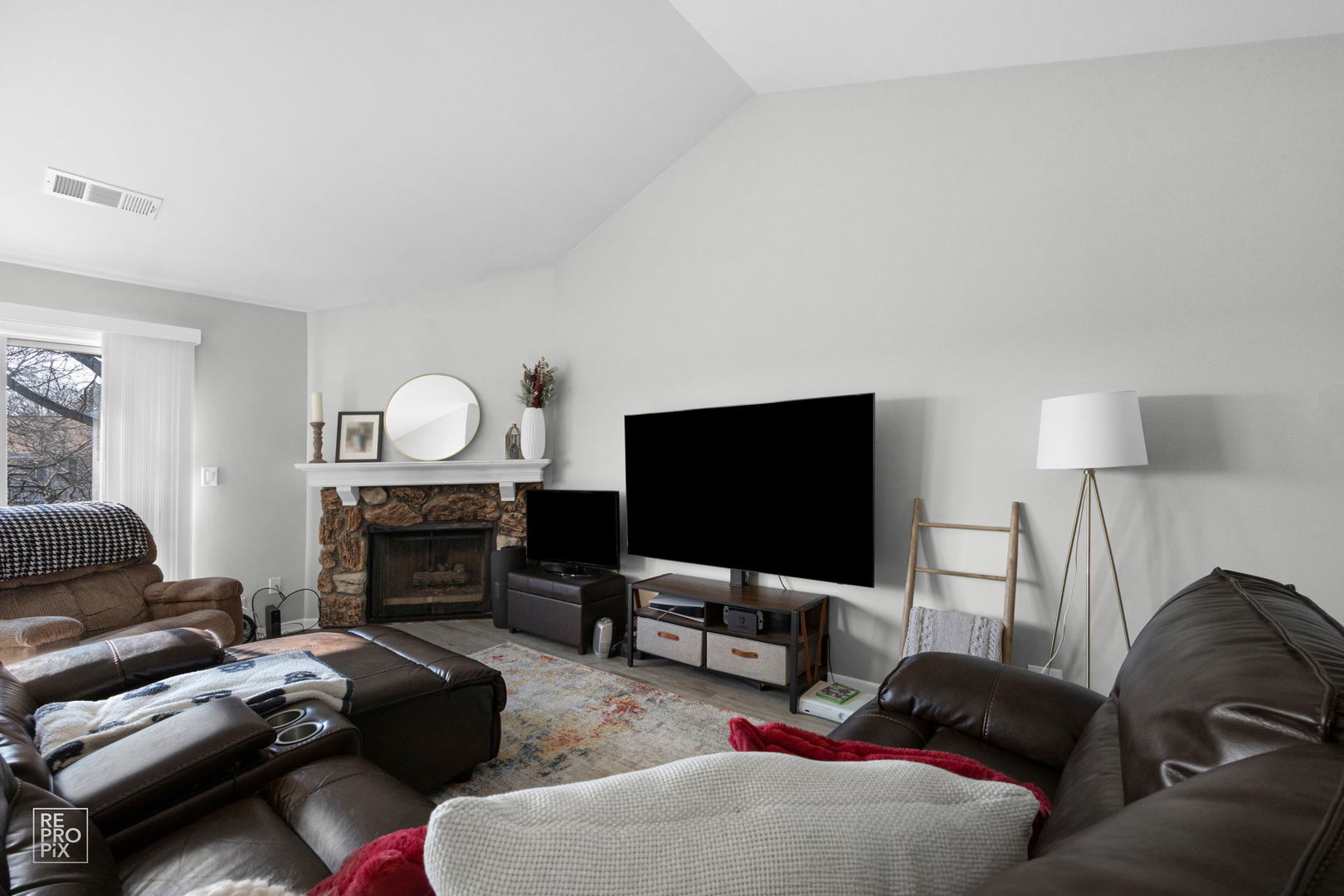 1588 Burr Oak Court, Unit B Wheaton, IL 60189 - Photo 3 of 10 a living room with furniture a fireplace and a flat screen tv