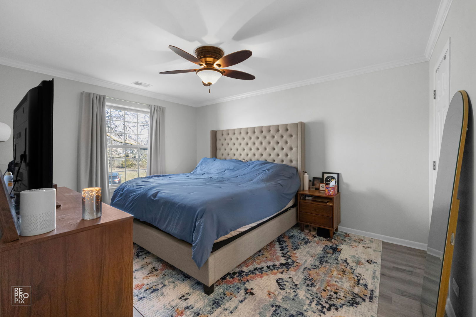 1588 Burr Oak Court, Unit B Wheaton, IL 60189 - Photo 7 of 10 a spacious bedroom with a bed and a flat screen tv