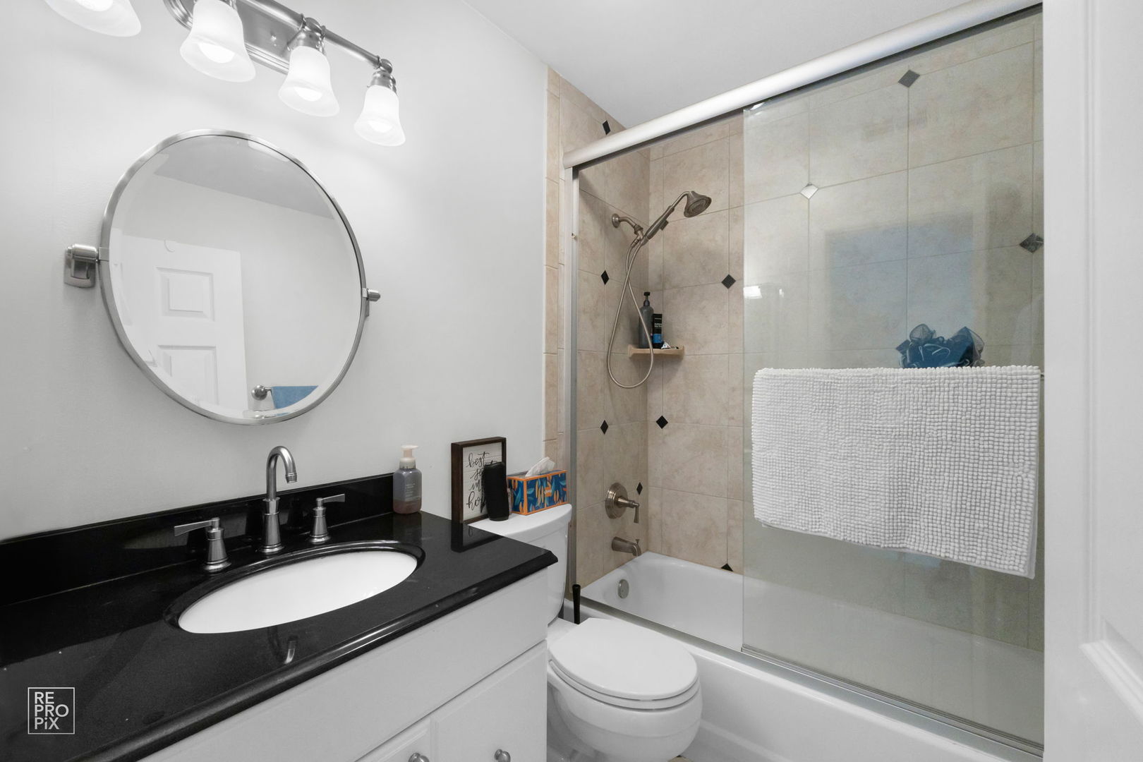 1588 Burr Oak Court, Unit B Wheaton, IL 60189 - Photo 8 of 10 a bathroom with a granite countertop sink mirror toilet and shower