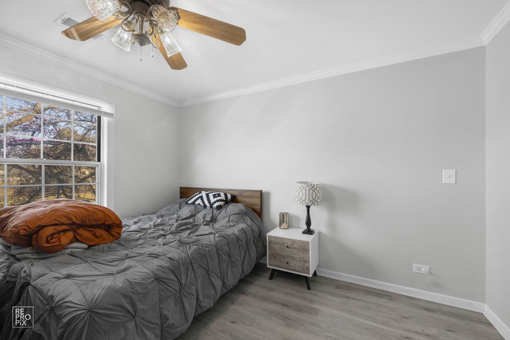 1588 Burr Oak Court, Unit B Wheaton, IL 60189 - Photo 9 of 10 a bedroom with a bed and a window