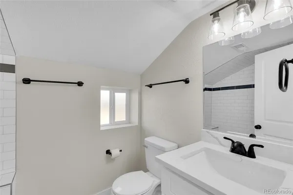 a bathroom with a tub a sink and a shower