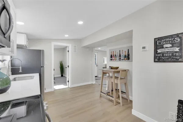 a view of a workspace with furniture and wooden floor