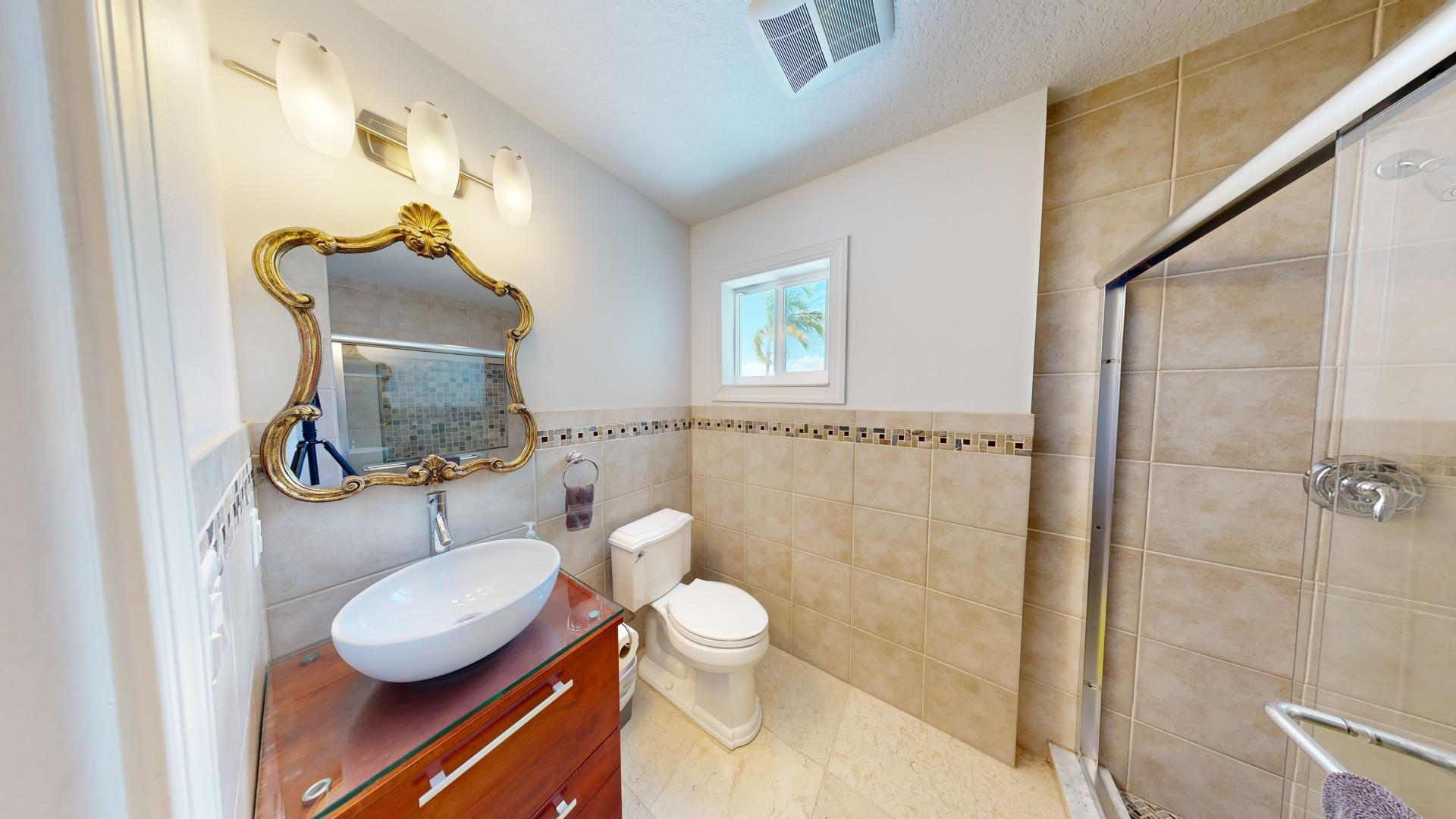 131 Coco Plum Road South Key Largo, FL 33037 - Photo 17 of 19 a bathroom with a granite countertop toilet sink and mirror