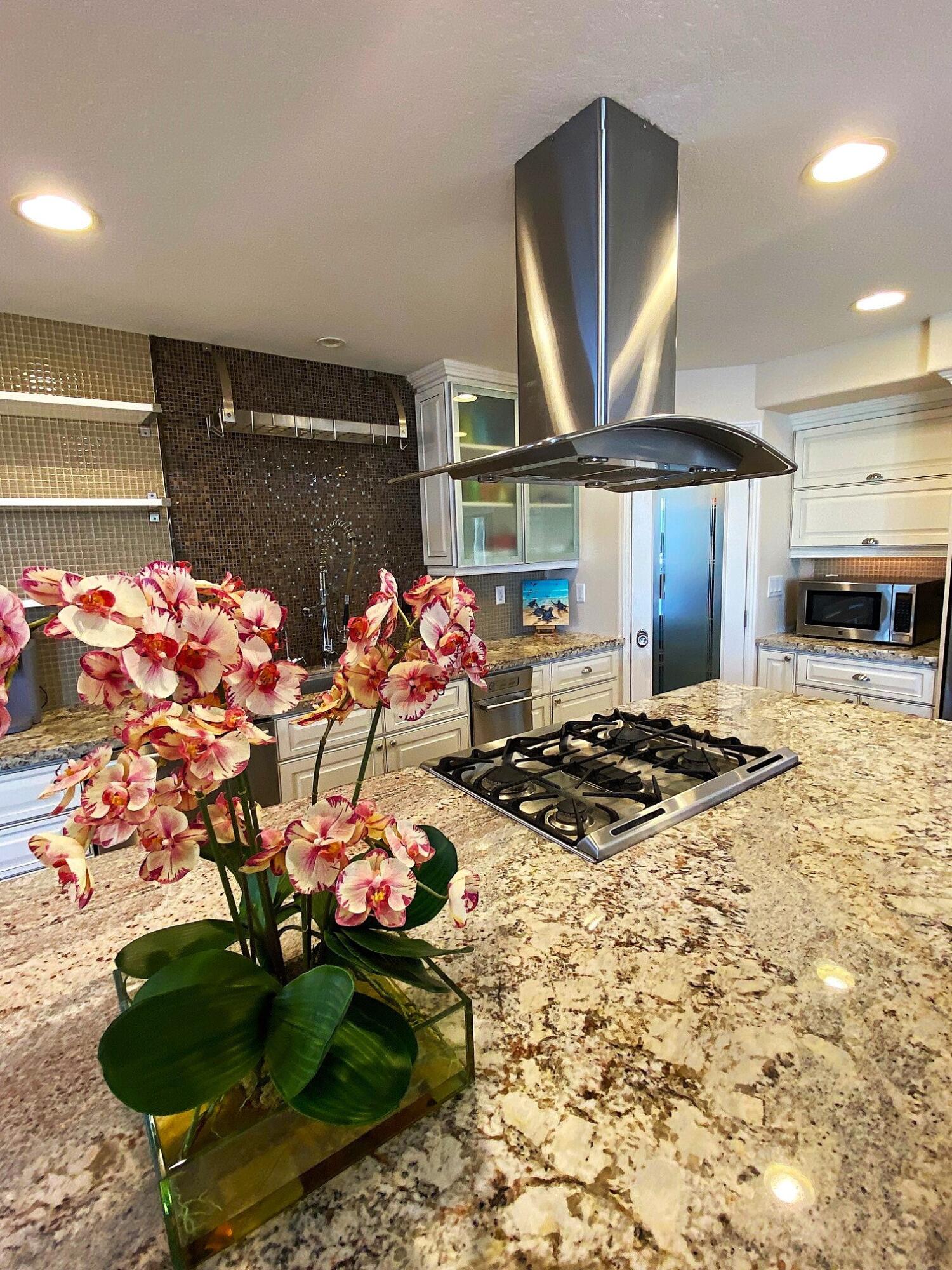 131 Coco Plum Road South Key Largo, FL 33037 - Photo 4 of 19 a kitchen with stainless steel appliances granite countertop a stove a sink and a refrigerator