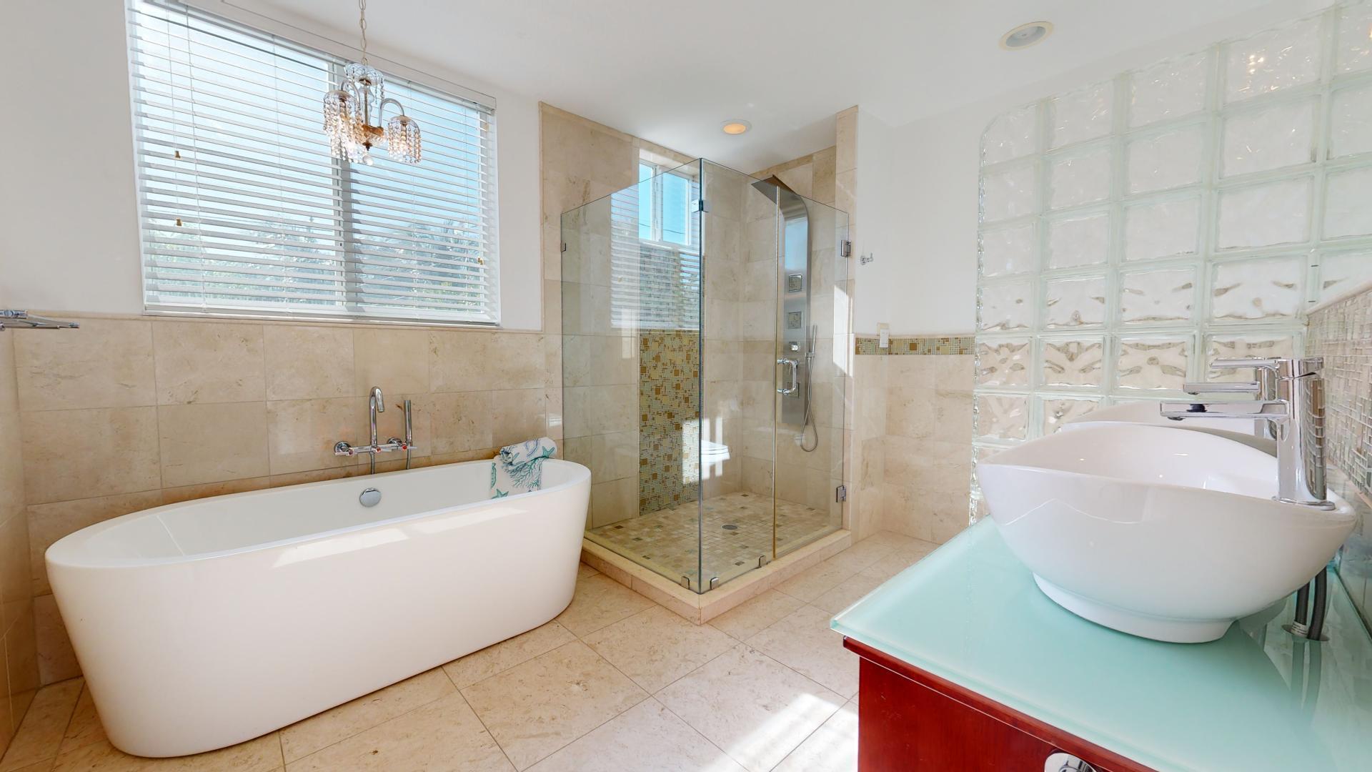 131 Coco Plum Road South Key Largo, FL 33037 - Photo 8 of 19 a bathroom with a bathtub and shower