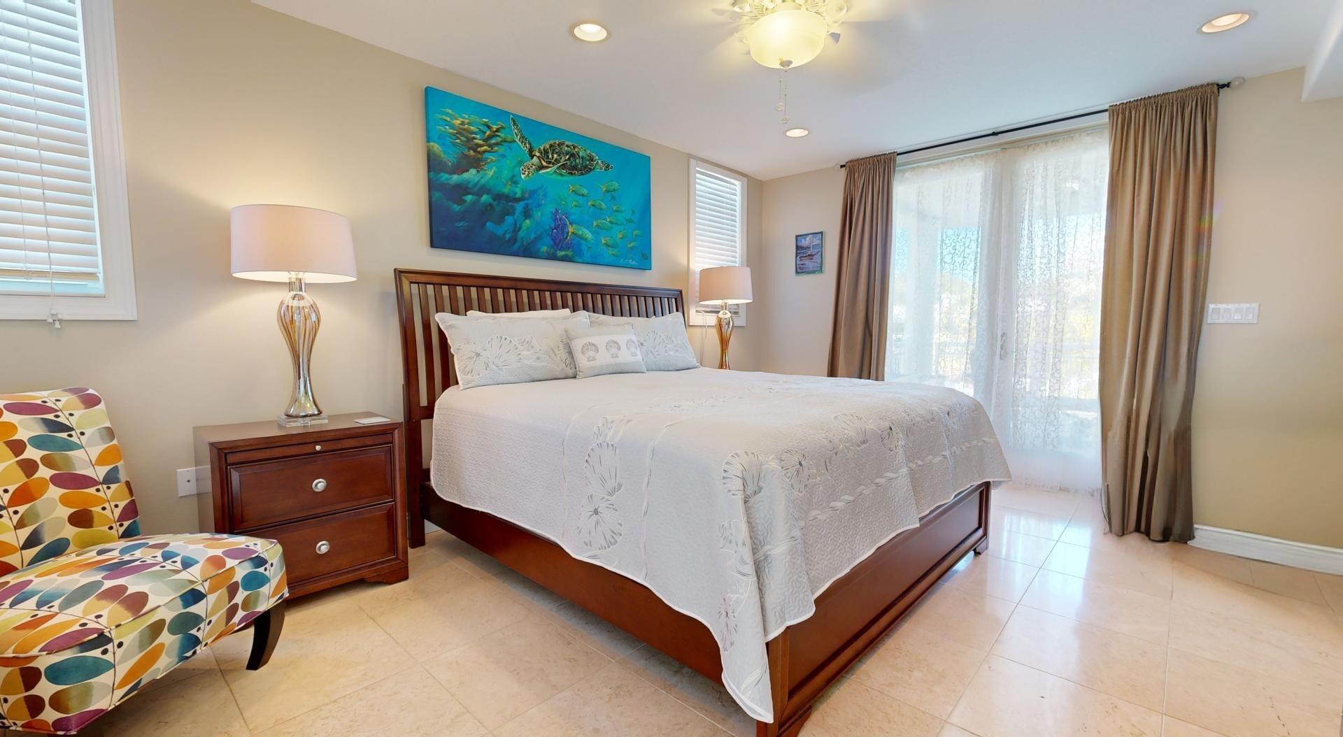 131 Coco Plum Road South Key Largo, FL 33037 - Photo 9 of 19 a bedroom with a bed and a window
