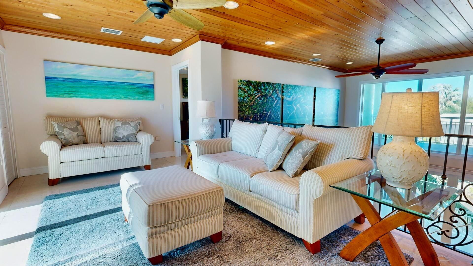 131 Coco Plum Road South Key Largo, FL 33037 - Photo 10 of 19 a living room with furniture and a flat screen tv