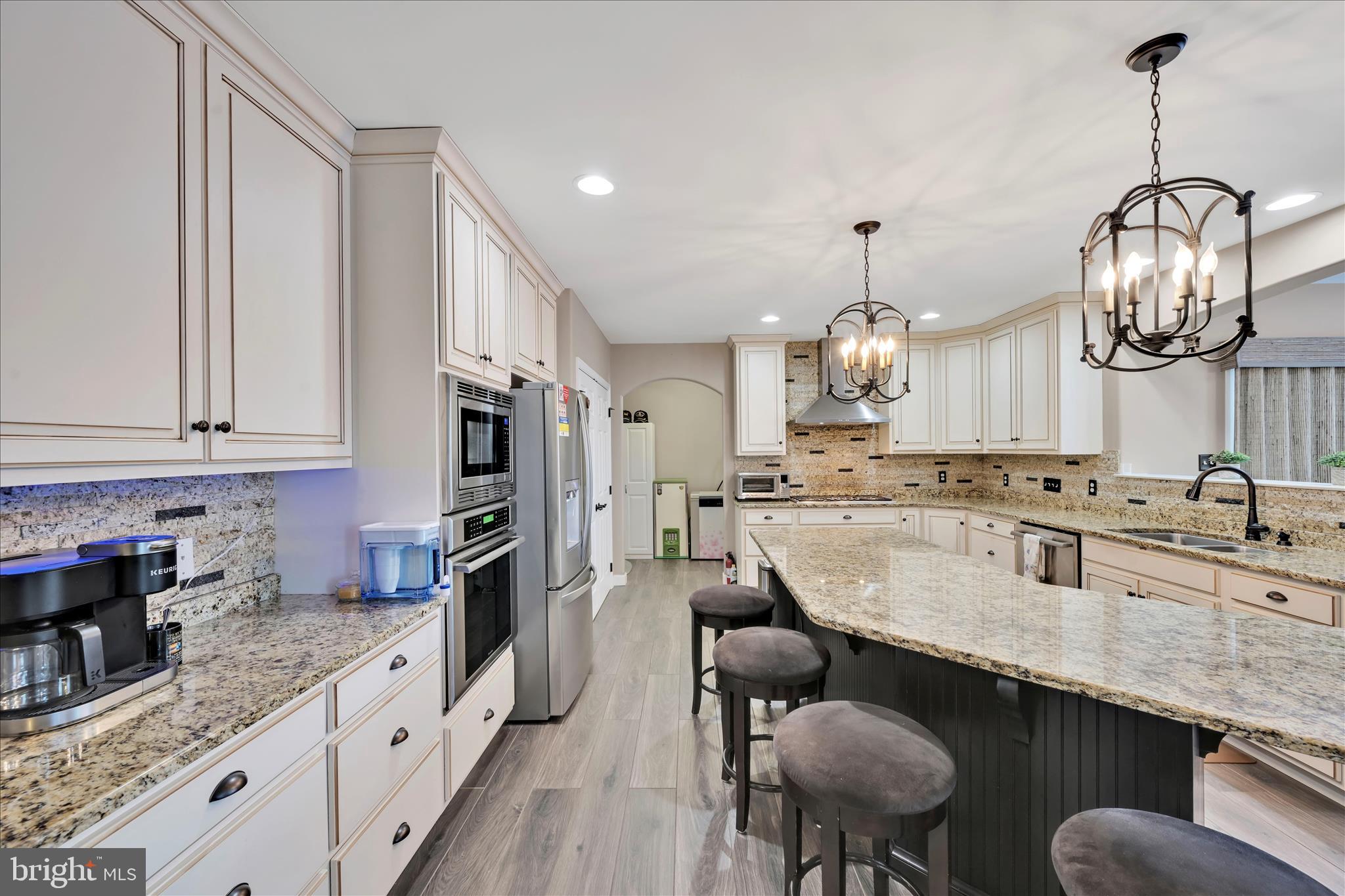 62 Stella Drive Reading, PA 19608 - Photo 14 of 41 a kitchen with stainless steel appliances granite countertop a sink counter space dining table and chairs