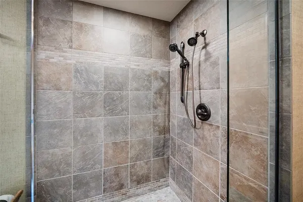 a bathroom with a granite countertop sink double vanity and a mirror