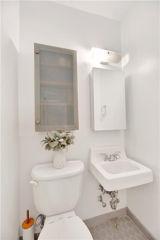 8940 Colonial Road, Unit 3 Brooklyn, NY 11209 - Photo 18 of 21 a bathroom with a sink toilet and mirror