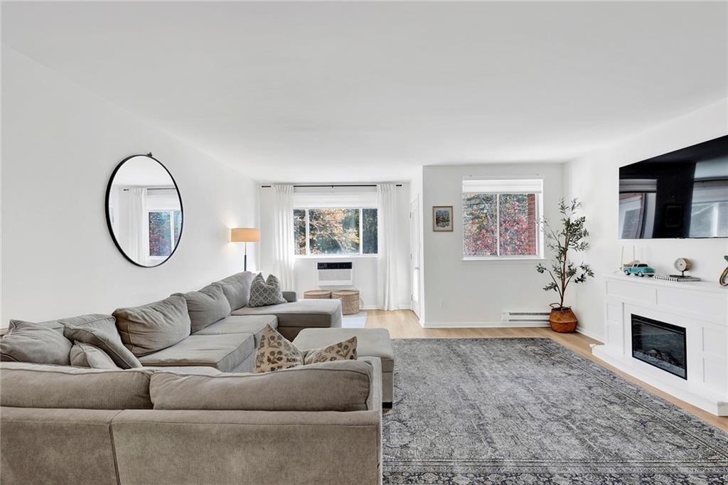 8940 Colonial Road, Unit 3 Brooklyn, NY 11209 - Photo 2 of 21 a living room with furniture a flat screen tv and a fireplace