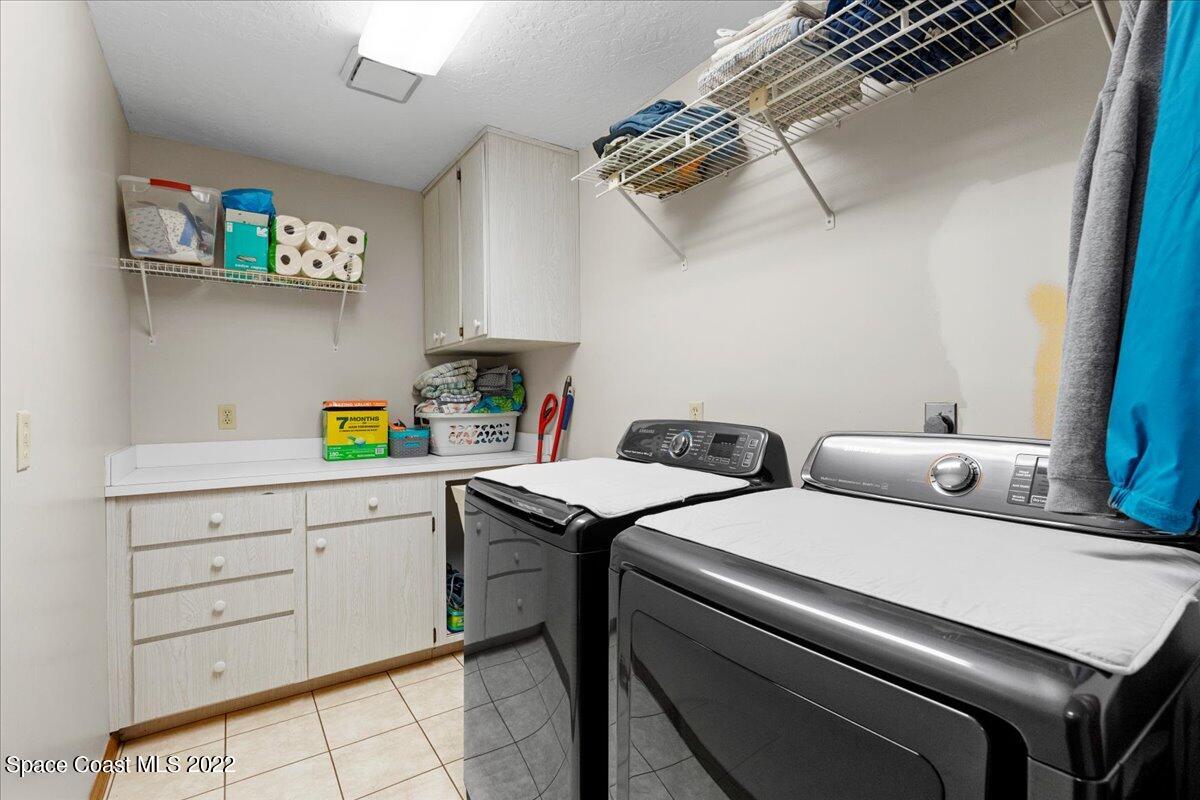 3205 Westland Melbourne, FL 32934 - Photo 12 of 55 a utility room with dryer and washer