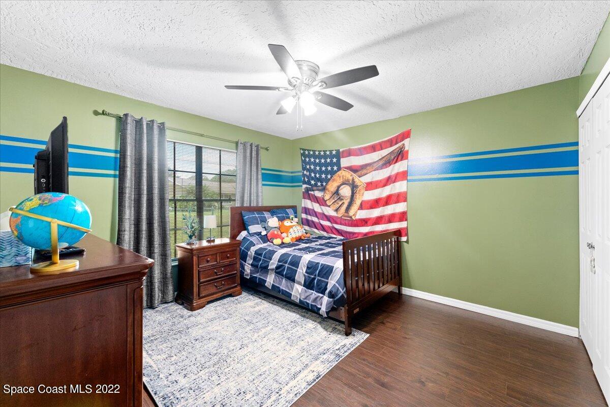 3205 Westland Melbourne, FL 32934 - Photo 13 of 55 a bedroom with a bed and a dresser