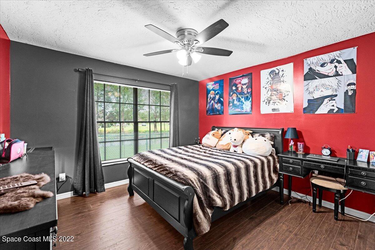 3205 Westland Melbourne, FL 32934 - Photo 14 of 55 a bed sitting in a bedroom next to a window