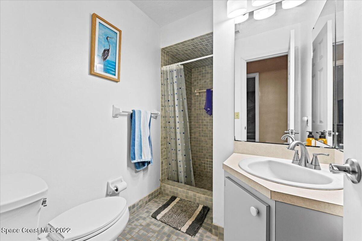 3205 Westland Melbourne, FL 32934 - Photo 17 of 55 a bathroom with a sink toilet and shower